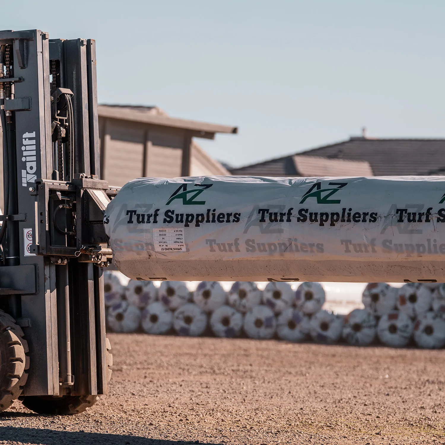 Forklift loading turf rolls for a contractor at the AZ Turf Suppliers yard